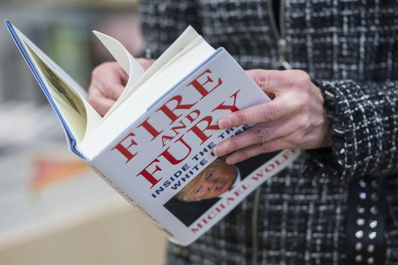 A man holds a copy of the book 'Fire and Fury: Inside the Trump White House' by Michael Wolff after buying it at a bookstore in Washington, DC on January 5, 2018.